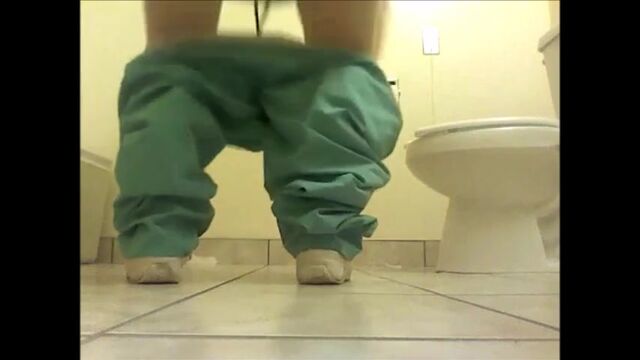 Girl shitting on the floor of the toilet