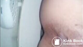 Woman shitting in the toilet closeup