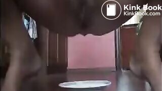 Woman shitting long turd on a plate