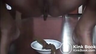 Woman shitting long turd on a plate