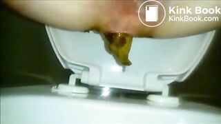 Woman shitting a long turd Closeup