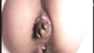 Girl shitting slowly a big turd closeup