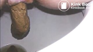 Woman shitting a long turd very slowly in the toilet