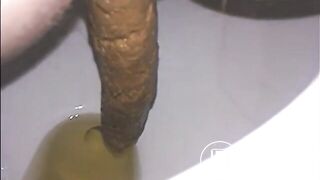 Woman shitting a long turd very slowly in the toilet