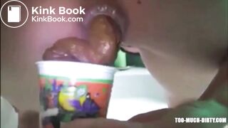 Girl shitting in a glass