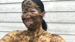 Asian woman smiles covered in scat