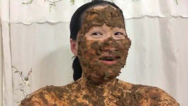 Asian woman laughs covered in scat