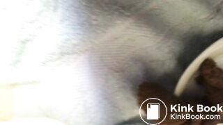 Hard shit peeks out of hole before dropping whole