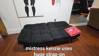 Dominatrix uses huge strap on her slave