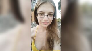 Girl pees secretly on a public beach in a swimsuit