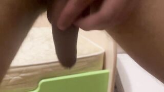 Wanking off in a crouch, arse to the camera. Fluid and cum drips down.
