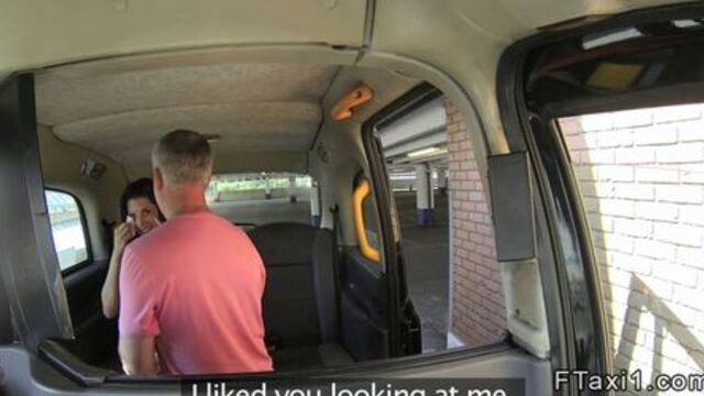 Brunette gives footjob in fake taxi