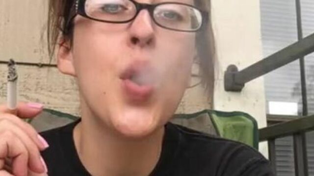 Nerdy Goddess D Smoking Cork Tip 100 Cigarette in Batman Shirt and Glasses