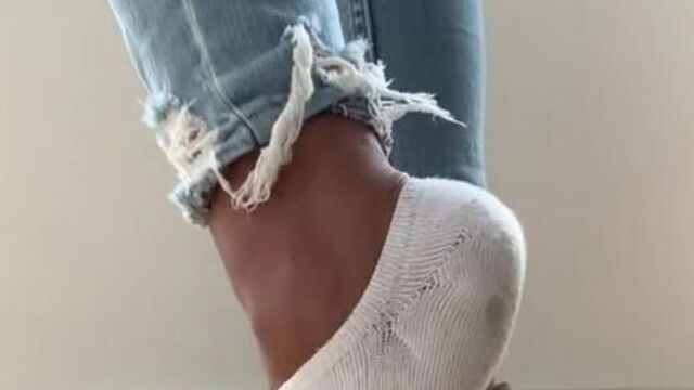 Sexy girl in stinky smelly dirty white socks and hot sneakers