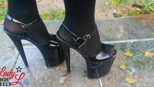 Lady L walking glas road with xtreme high heels.