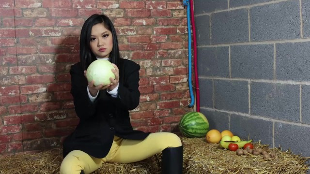 Equestrian Louisa crushing fruit wearing boots