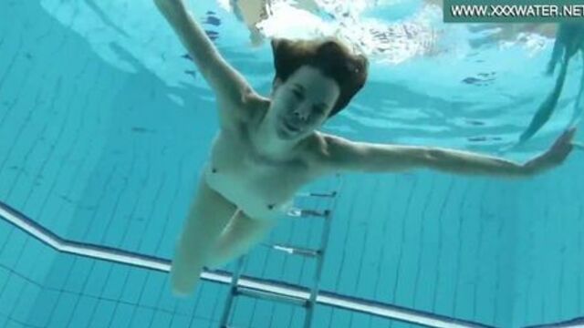 Podvodkova swimming in blue bikini in the pool