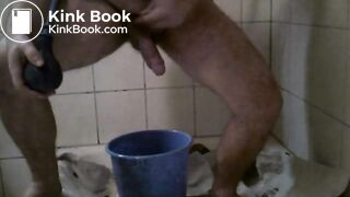 chubby gay guy smearing poop from a tub