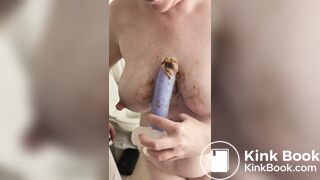 Nervously smearing her dirty dildo on her tits