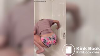 Blackras poops her panties squatted over bathtub