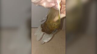 Girl puts hand into dirty glove