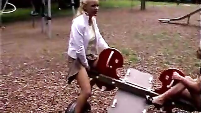 Women peeing on seesaw in playground