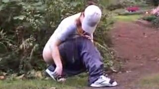 CONSUMING FECES OUTDOORS IN THE PARK