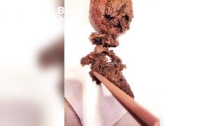 Chinese girl plays with her shit with chopsticks