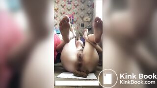 Cute girl struggles to push out a hard log