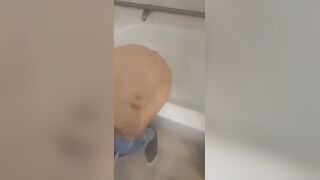 Girl makes mess in bath.
