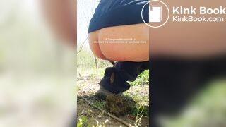 The girl is defecating outdoors