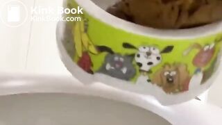 Filling a bowl for the dog with a big poo..