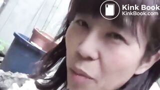 A Japanese woman poops in a back alley.