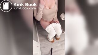 Sexy girl in white leggings having diarrhea on toilet
