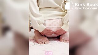 Chinese girl messes and sits in diaper
