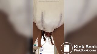 Girl pooping in her diaper.