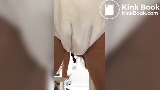 Girl pooping in her diaper.
