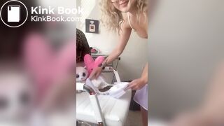 Woman pooping on diaper placed on chair