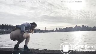 girl shitting in a lake shore