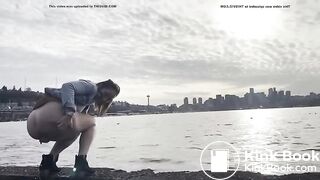 girl shitting in a lake shore