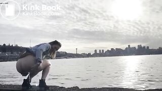 girl shitting in a lake shore
