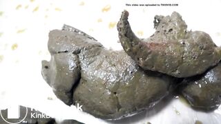 LIttle Asian woman drops a thick black dump.