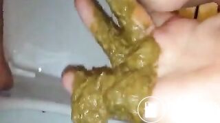 Fingering her ass while she's pooping