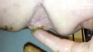Fingering her ass while she's pooping