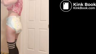 Cute girl poops diaper in front of door