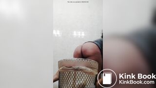 Ebony shitting into a trash can