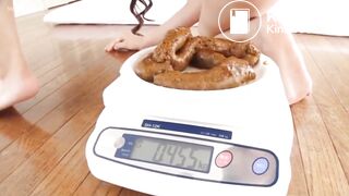 Pretty Asian girl pushing out a big load!