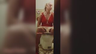 Girl in a red dress pissing at a party