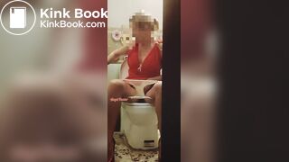 Girl in a red dress pissing at a party