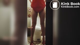 Girl in a red dress pissing at a party